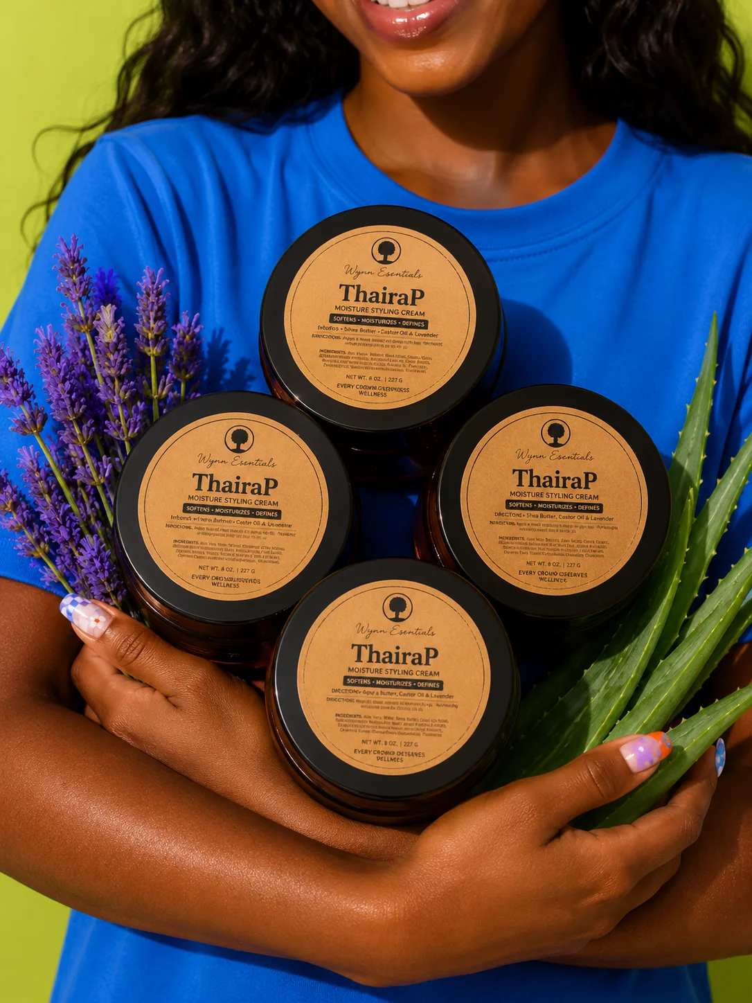 Model holding four ThairaP jars beside lavender and aloe