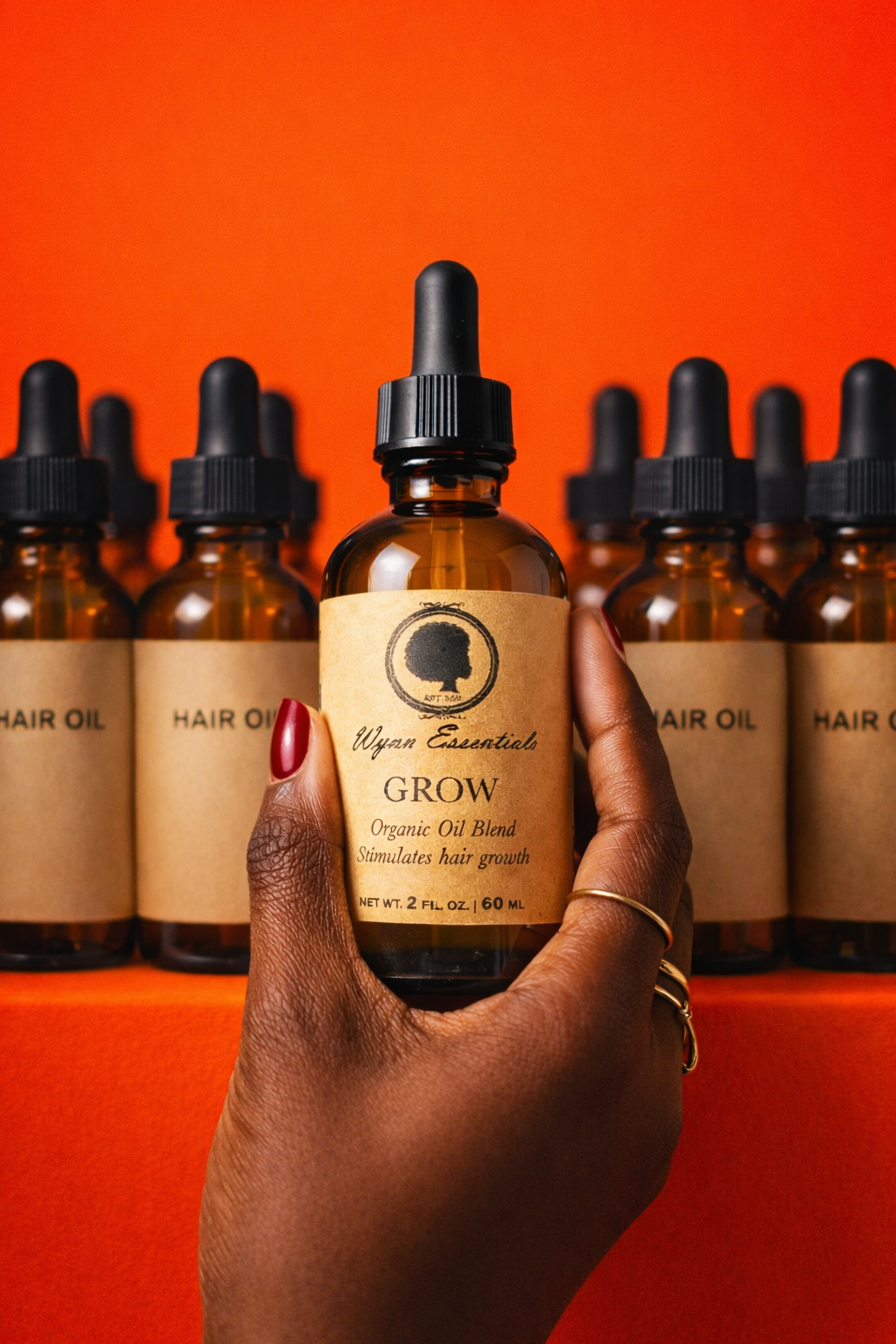 Grow Oil bottle held in front of a coordinated product lineup
