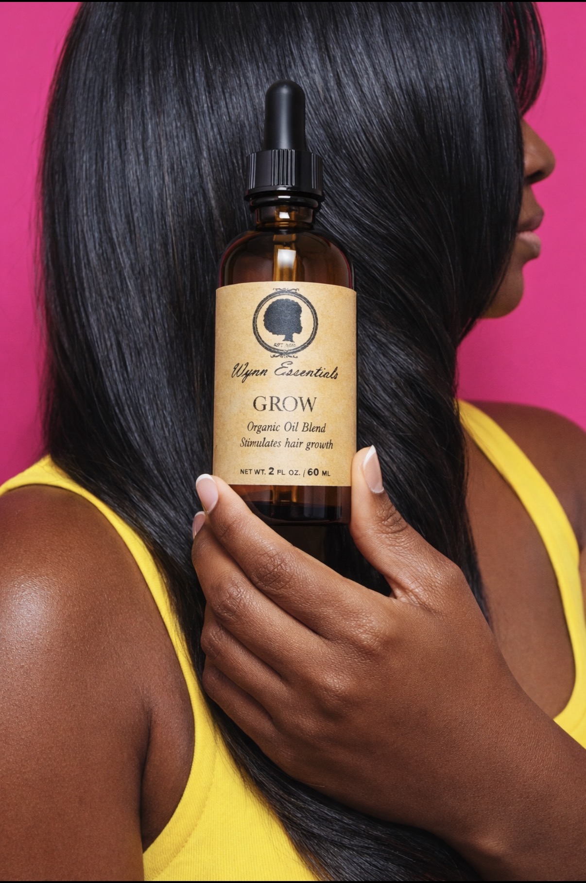 Grow Oil displayed in front of long sleek hair