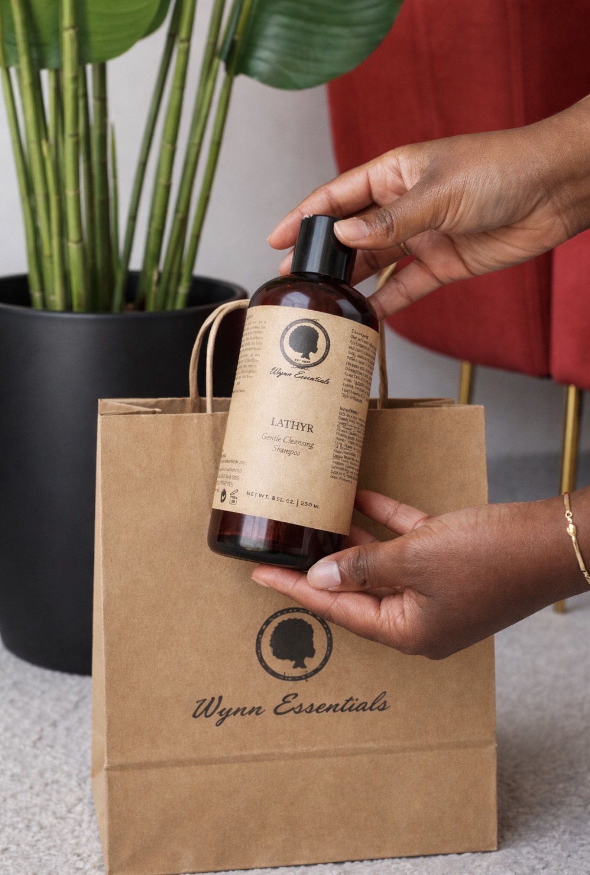 Lathyr shampoo displayed with a Wynn Essentials shopping bag