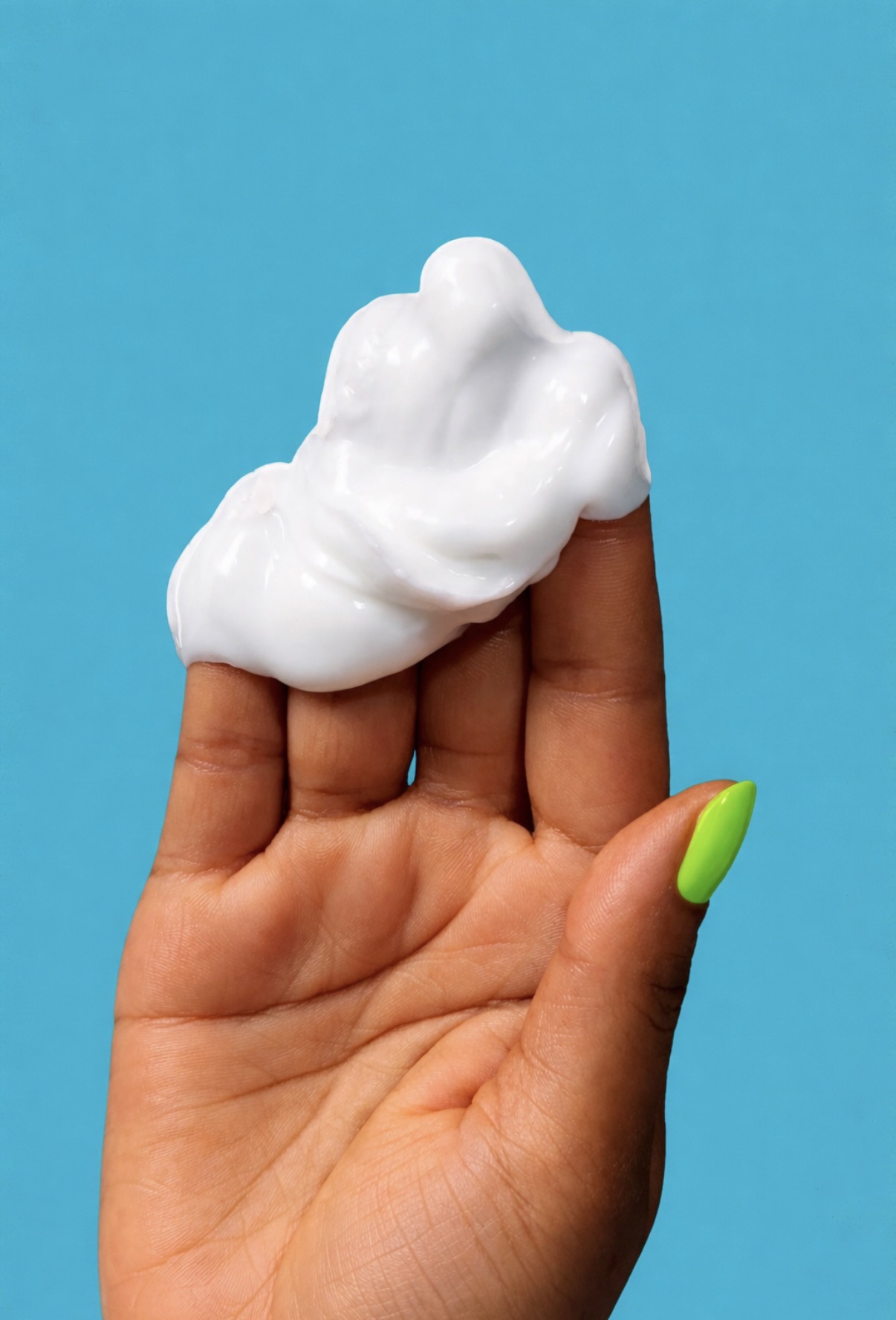 Rich white conditioner texture displayed on a hand